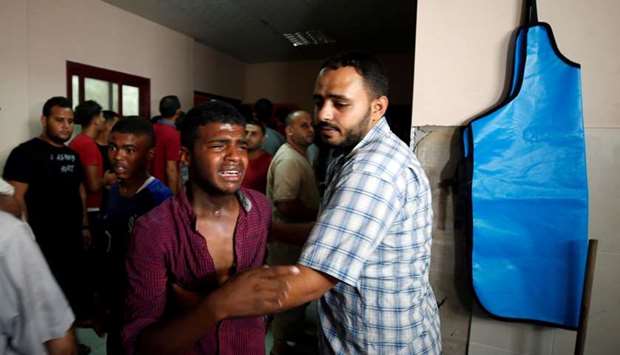 A relative of a Palestinian Hamas militant who was killed in Israeli tank shelling, reacts at a hospital in the northern Gaza Strip