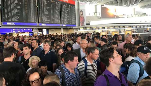 People are seen waiting at the Frankfurt Airport due to the evacuation in Frankfurt