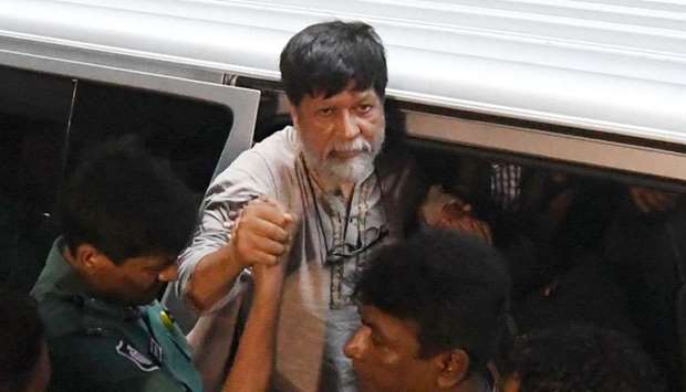 Bangladeshi policemen arrive with activists and photographer Shahidul Alam for an appearance in a court, in Dhaka
