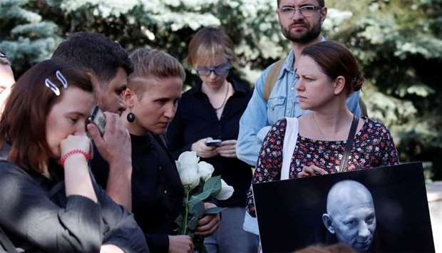 People mourn during a funeral ceremony for Rastorguyev, one of three Russian TV journalists killed in volatile Central African Republic, in Moscow