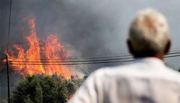 A man watches the progress of a wildfire close to Monchique, in Algarve on Tuesday.