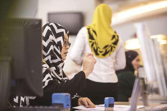 An employee serves a customer (unseen) at a combined Malayan Banking (Maybank) and Maybank Islamic bank branch in Kuala Lumpur (file). It is still the case that a variety of different Shariah governance models exist in  different jurisdictions, often even varying from bank to bank in the same country.