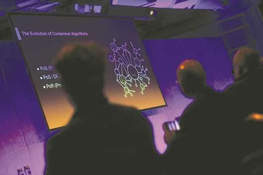 Attendees look at a diagram titled u201cThe Evolution of Consensus Algorithmsu201d relating to  blockchain developments on a screen during the Crypto Investor Show in London (file).  Digital tools such as blockchain can support Islamic trade finance by helping to lower costs and speed up Shariah-compliant transactions, according to a report last month.