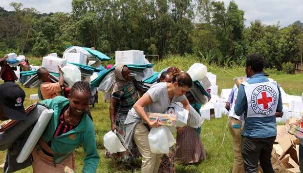 International Committee of the Red Cross volunteers distribute emergency assistance to people displaced by ethnic violence in Ethiopia.