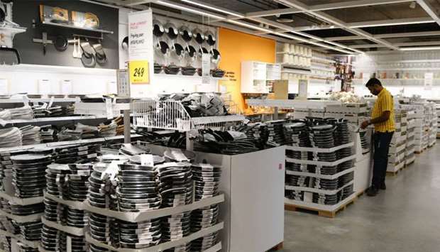 An Indian worker arranges pans at the kitcheware section of the new IKEA store in Hyderabad