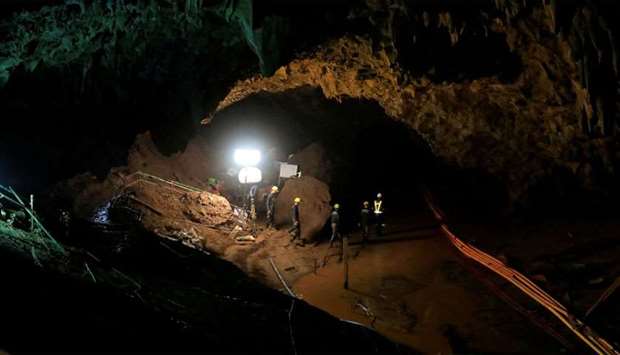 Rescue workers follow 12 soccer players and their coach out of Tham Luang cave complex in the northern Thailand