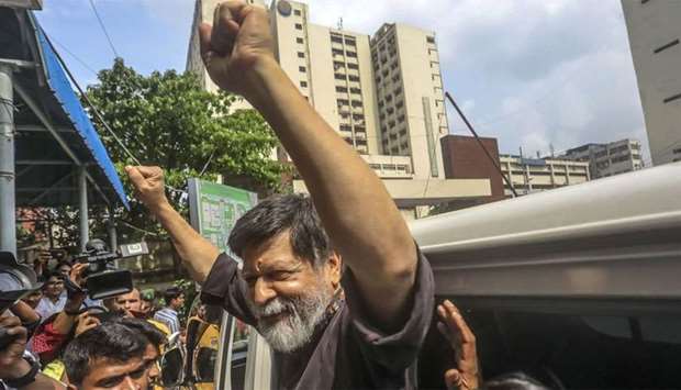 Renowned Bangladeshi photographer Shahidul Alam, 63, gestures in a hospital in Dhaka
