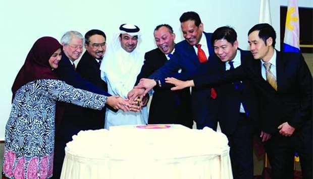 Asean heads of missions, along with Qataru2019s Ministry of Foreign Affairsu2019 Asian Department deputy director Rashid al-Dehaimi, led the ceremonial cutting of cake to mark the 51st Asean Day celebration in Doha on Wednesday. PICTURE: Nasar TK