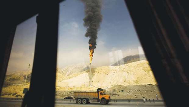 A gas flame is seen through a bus window in the South Pars gas field facilities in the Iranian port of Assaluyeh (file). Turkey is dependent on imports for almost all of its energy needs and Iran is a key supplier of Ankarau2019s natural gas and oil purchases.