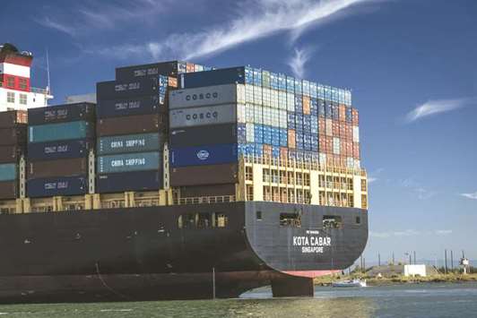 Shipping containers sit stacked on a cargo ship at the Port of Oakland, California. Chinau2019s trade surplus with the US stood at $28.1bn, close to the record-high in June, data released yesterday showed.