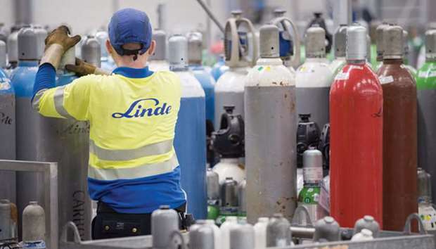 A worker manoeuvres an empty canister inside the Linde AG compressed gas plant in Marl, Germany. The decision to dispose of the onsite and speciality gas businesses hasnu2019t been finalised and would still need approval from Lindeu2019s supervisory board, sources said.