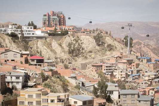 SCENERY: A trip on the cable car connecting the Bolivian capital, La Paz, with the satellite city of El Alto offers stunning views of the Illimani Mountain.