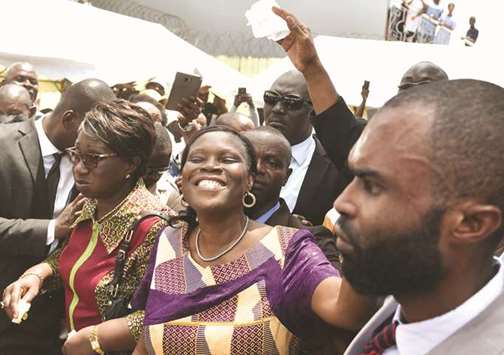 Former Ivory Coast first lady Simone Gbagbo, who had been serving a 20-year jail term, gestures as she arrives at her home after she was released, two days after being  amnestied yesterday, in Abidjan.