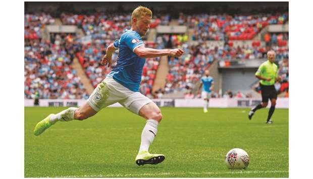 In this August 4, 2019, picture, Manchester Cityu2019s Kevin De Bruyne runs with the ball during the English FA Community Shield match against Liverpool at Wembley Stadium in London. (Right) Manchester Cityu2019s Spanish manager Pep Guardiola. (AFP)
