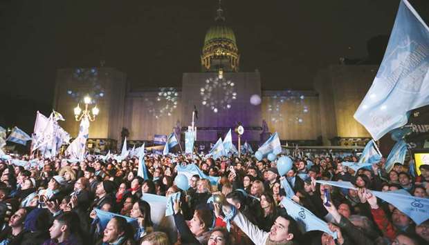 Anti-abortion rights activists hold white blue scarfs as they demonstrate outside the National Congress, in Buenos Aires yesterday.