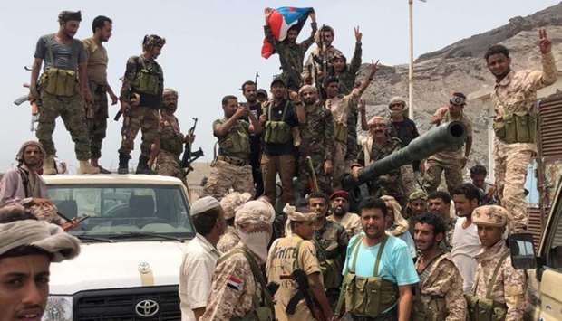 Yemeni supporters of the southern separatist movement pose for a picture in Khor Maksar, Aden