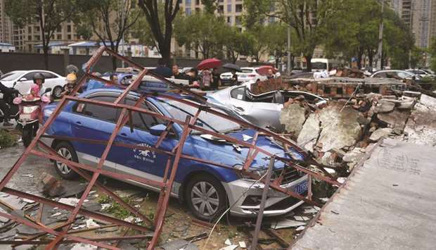 Cars are damaged after Typhoon Lekima made landfall in Wenling, Zhejiang province, China, yesterday.