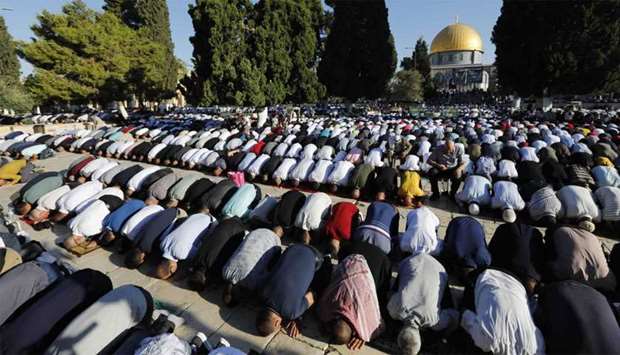 Palestinian worshippers perform the Eid al Adha morning prayers at the Al-Aqsa Mosque compound in the Old City of Jerusalem