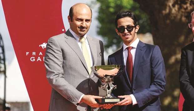 QREC Board member Khalifa bin Mohamed al-Attiyah presents the owneru2019s trophy to Khalifa bin Sheail al-Kuwari after Sheail bin Khalifa al-Kuwariu2019s Lady Princess won the Al Rayyan Cup. (Zuzanna Lupa)
