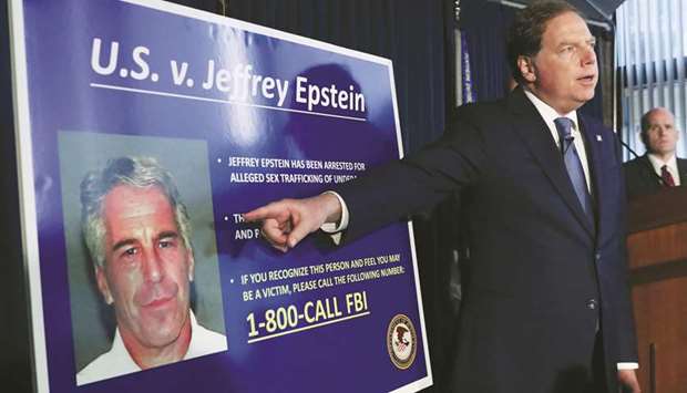 This picture taken on July 8 shows Geoffrey Berman, US attorney for the Southern District of New York, pointing to a photograph of Epstein as he announces the financieru2019s charges of sex trafficking of minors and conspiracy to commit sex trafficking of minors, in New York.