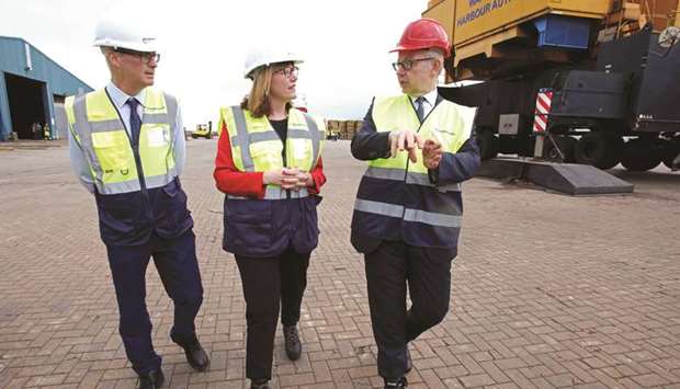 Chancellor of the Duchy of Lancaster Michael Gove speaks with Clare Guinness (centre), chief executive officer of Warrenpoint Harbour, and Kieran Grant, finance director of Warrenpoint Harbour Authority, on a visit to the border between Northern Ireland and Republic of Ireland at Warrenpoint Port on Saturday.