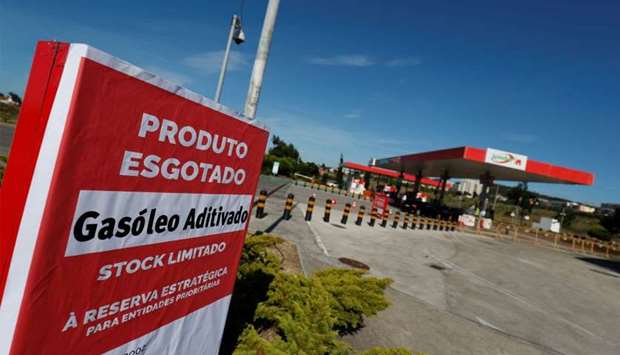 A placard reading ,Diesel sold out, is seen at a gas station in Lisbon, Portugal
