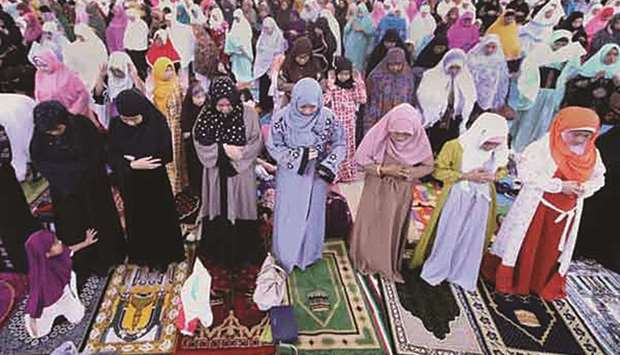 People pray during the celebration of Eid al-Adha at the Quezon City Memorial Circle.