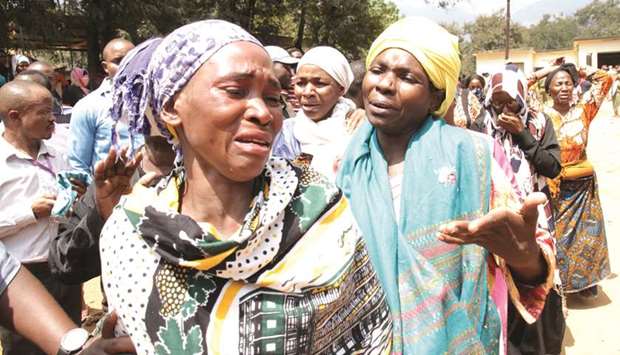 Relatives mourn their dead kin outside the Morogoro referral hospital, after a fuel tanker exploded killing a crowd of people collecting liquid from puddles in jerricans in Morogoro, eastern Tanzania, yesterday.