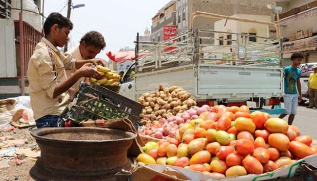 A fruit peddlar sells produce from a cart along a market street in the Crater district in the centre of Yemen's second city of Aden
