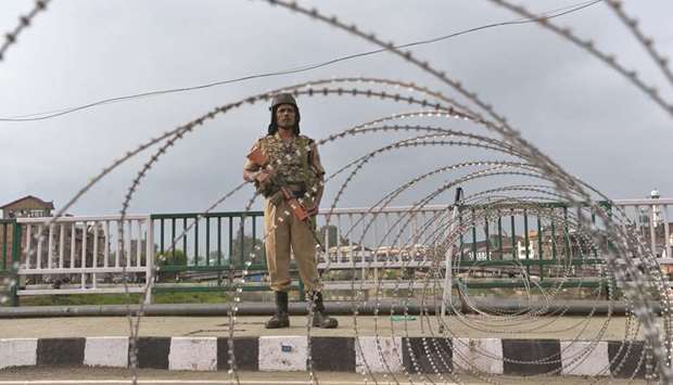 A security personnel stands guard on a street during a lockdown in Srinagar on August 11, after the Indian government stripped Jammu and Kashmir of its autonomy.