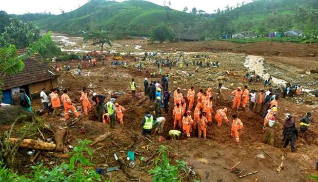 Volunteers, local residents and members of National Disaster Response Force (NDRF) search for survivors in the debris left by a slandslide at Puthumala at Meppadi in the Wayanad district, in the Indian state of Kerala