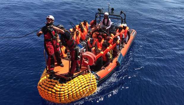 A ,rhib,, an inflatable dinghy, belonging to the 'Ocean Viking' rescue ship, operated by French NGOs SOS Mediterranee and Medecins sans Frontieres (MSF), transports migrants rescued from their dinghy during an operation in the Mediterranean Sea