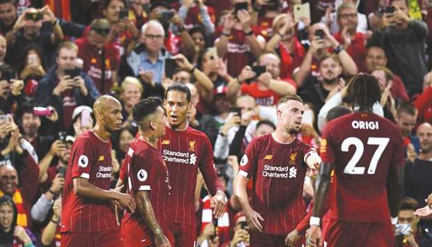 Liverpoolu2019s defender Virgil van Dijk (third left) celebrates with teammates after scoring against Norwich City during the Premier League match last week. (AFP)