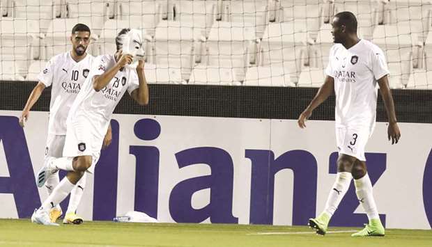 Al Saddu2019s Akram Afif (second from right) wears a wolf mask in celebration of scoring a goal as teammates Hassan al-Haydos (left) and Abdelkarim Hassan look on during the second leg of the AFC Champions League Round of 16 match against Al Duhail yesterday. PICTURES: Jayaram