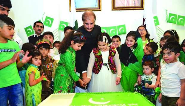 The ambassador along with children from Pakistani community cutting a cake on the occasion.