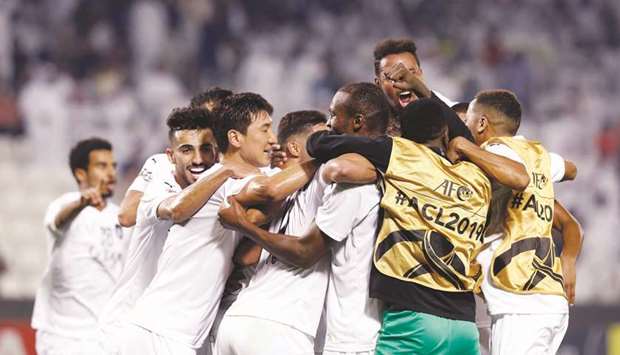 Al Sadd players celebrate their victory over Al Duhail in their AFC Champions League Round of 16 match on Tuesday. PICTURES: Jayaram/AFP