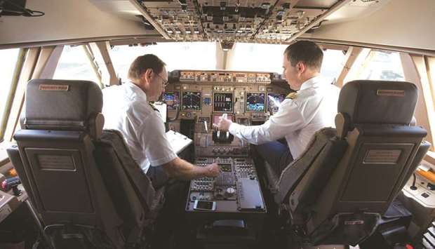 A Deutsche Lufthansa pilot and co-pilot sit in the cockpit of a Boeing 747-8 passenger aircraft before take off at Frankfurt Airport. Global air traffic is set to double in the next two decades, according to IATA. Boeing Company forecasts the Asia-Pacific region needs some 16,930 new planes and about 261,000 pilots through 2037.