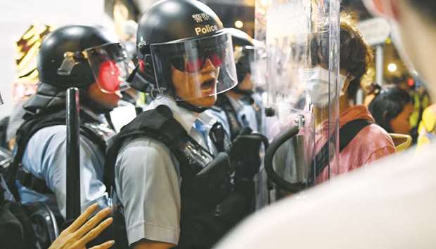 A policeman shouts at a pro-democracy protestor to move out of his way during a gathering in the Sham Shui Po Area of Hong Kong yesterday.