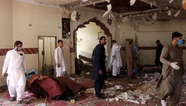 Members of a bomb disposal unit survey the site after a blast at a mosque in Kuchlak, in the outskirts of Quetta, Pakistan. Reuters