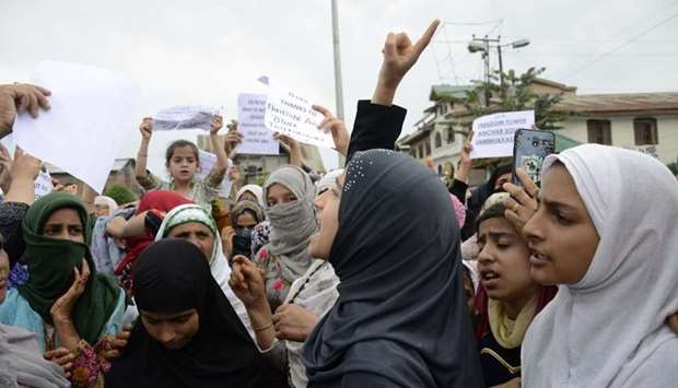 Protesters shout slogans at a rally against the Indian government's move to strip Jammu and Kashmir of its autonomy and impose a communications blackout, in Srinagar