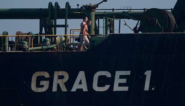 Crew members of Iranian supertanker Grace 1 walk on board off the coast of Gibraltar yesterday.