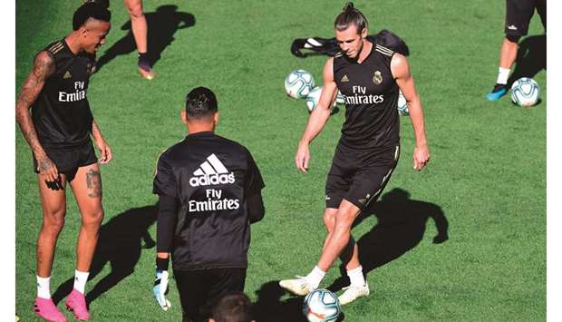 Real Madridu2019s Eder Militao (left) and Gareth Bale (right) take part in a training session in Madrid yesterday. (AFP)