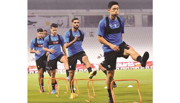 Al Sadd players take part in a training session on the eve of their Sheikh Jassim Cup match against Al Duhail at Jassim bin Hamad Stadium Friday. PICTURE: Nasar TK
