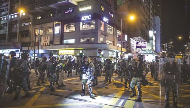 Riot police stand off against demonstrators during a protest in the Causeway Bay district of Hong Kong. The Asian financial centre is on the verge of its first recession in a decade as increasingly violent anti-government protests scare off tourists and bite into retail sales in one of the worldu2019s most popular shopping destinations.