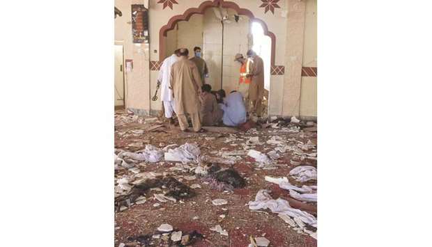 Security officials examine the blast site at a mosque in the town of Kuchlak, southwest Quetta.