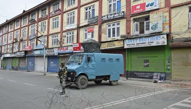 A member of the Indian security forces stands guard during a lockdown in Srinagar