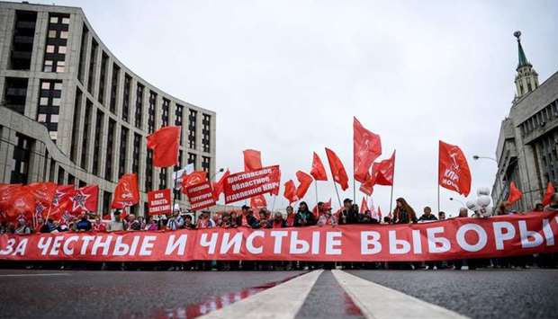 Russian Communist Party members and supporters attend a protest rally against the exclusion of some city council candidates from Moscow's upcoming election in central Moscow