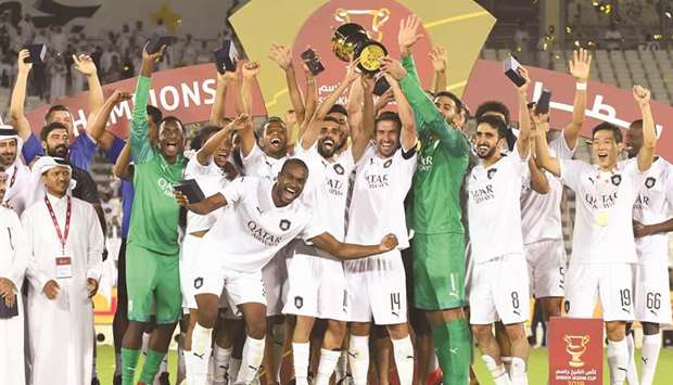 Al Sadd players lift the Sheikh Jassim Cup after their win over Al Duhail in the match at Jassim Bin Hamad Stadium Saturday. PICTURES: Noushad Thekkayil and Shemeer Rasheed