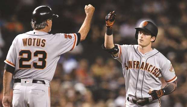 San Francisco Giants right fielder Mike Yastrzemski (right) bumps fists with third base coach Ron Wotus after hitting a solo home run against the Arizona Diamondbacks during the third inning at Chase Field. PICTURE: USA TODAY Sports