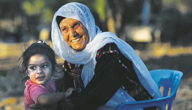 Muftia, the grandmother of US congresswoman Rashida Tlaib, is seen with her granddaughter outside her house in the village of Beit Ur Al-Fauqa in the occupied West Bank.